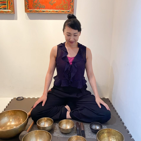 Yoga instructor with crystal bowls