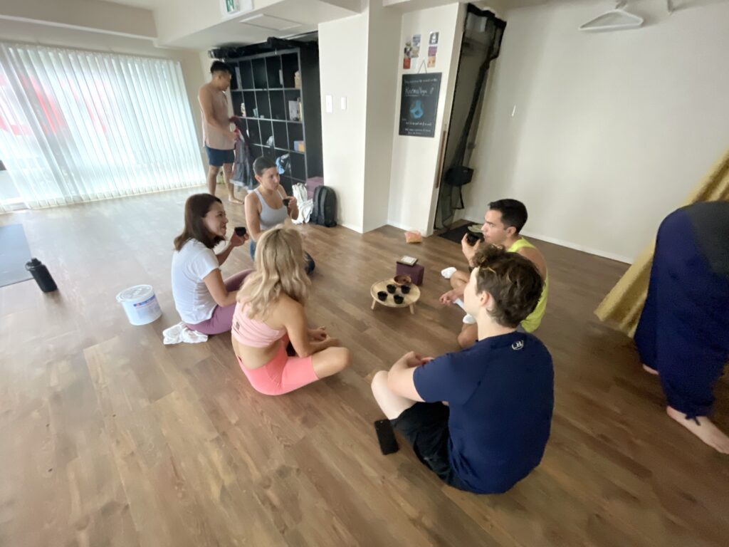 yoga students having tea after yoga class in English